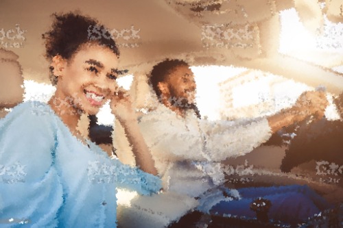 smiling-man-looking-at-female-friend-in-car-during-road-trip-MASF20688.jpg